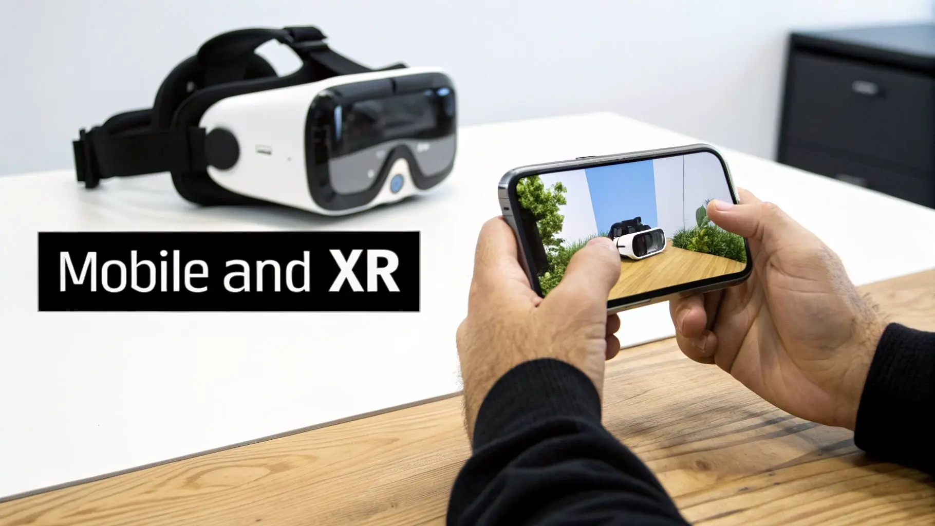 Hands hold a smartphone displaying an augmented reality view of a VR headset next to a real VR headset, labeled 'Mobile and XR'.