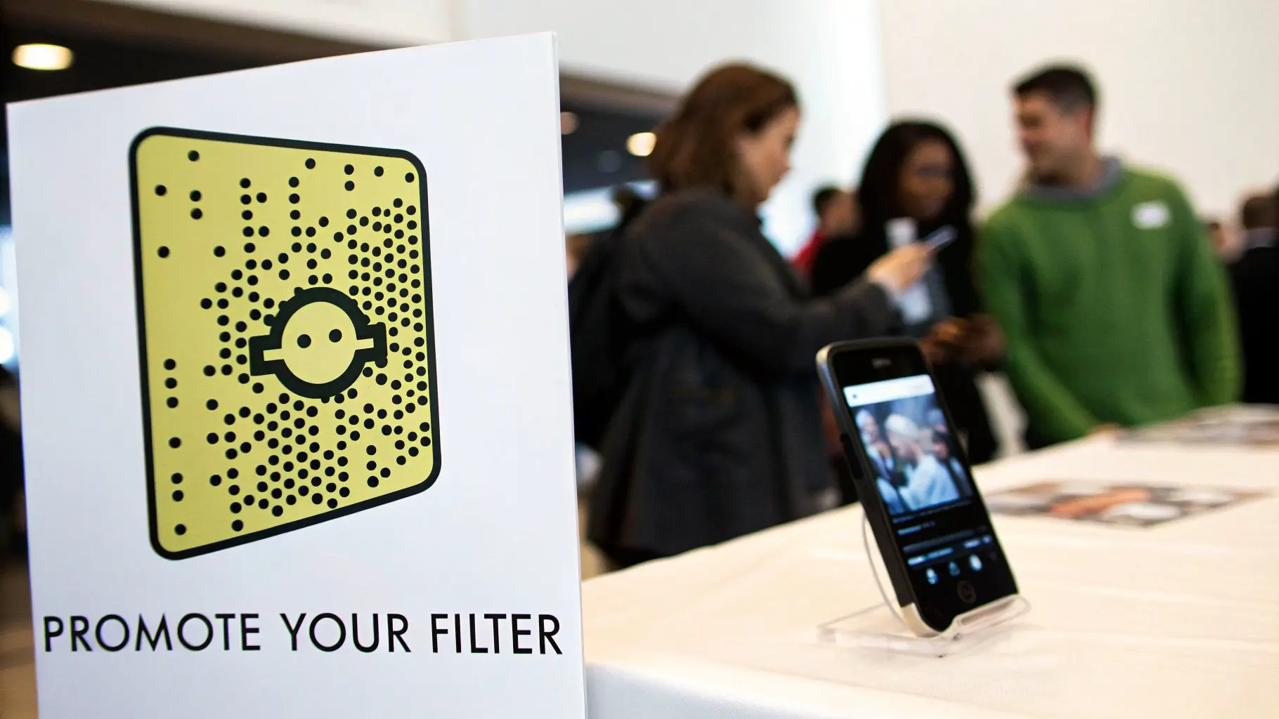 A white sign displaying a yellow Snapchat Snapcode and 'PROMOTE YOUR FILTER' text.