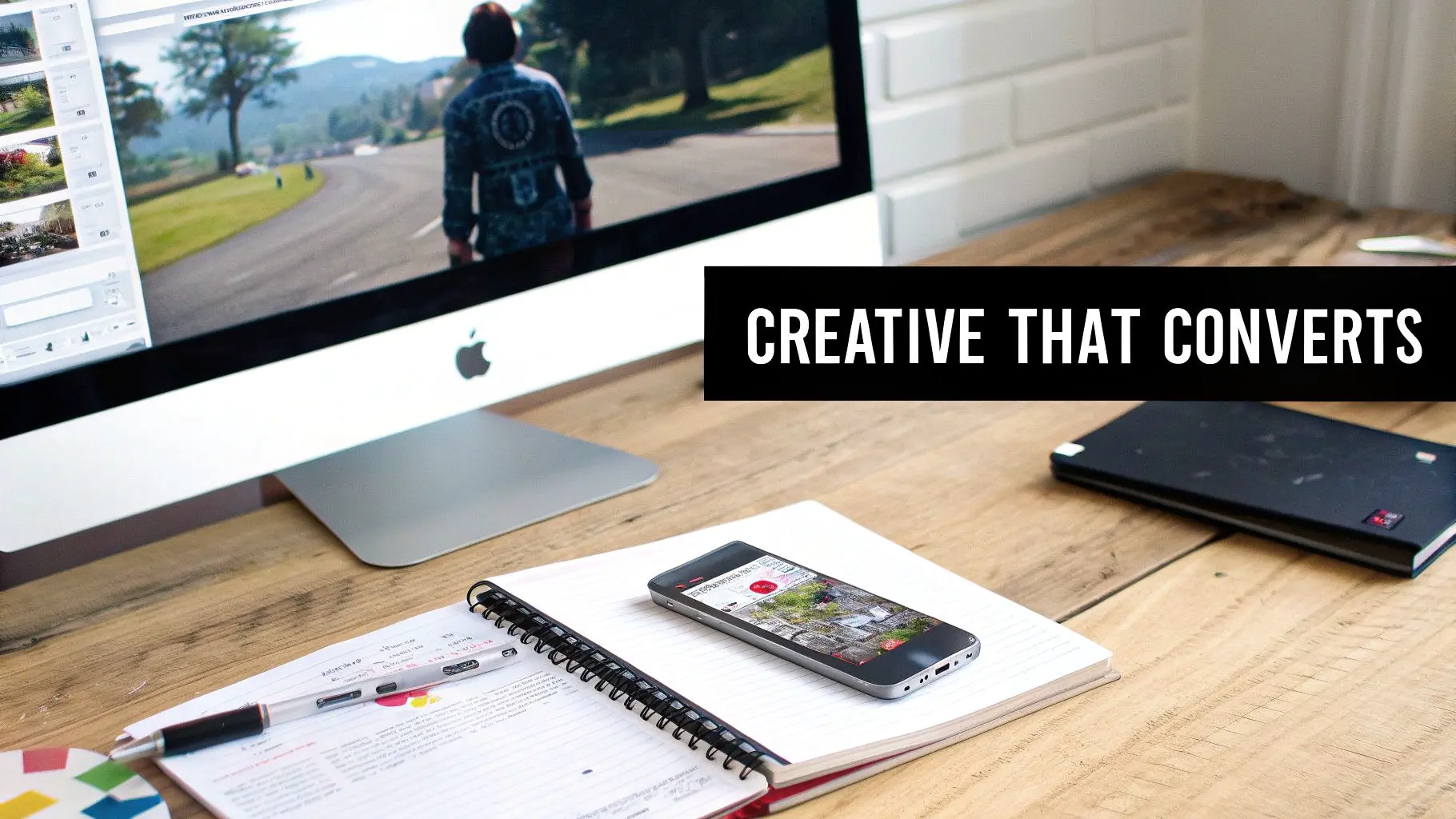 A person using a stylus to draw on a tablet, representing the creative process of designing game ads.