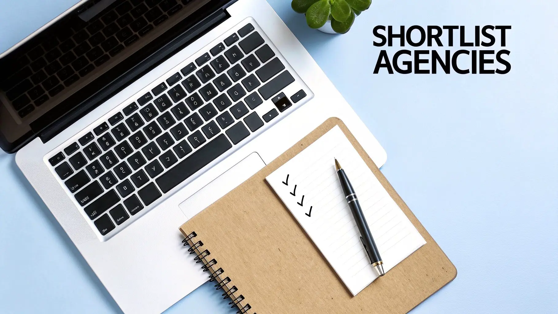 A team reviewing mobile app development agency profiles on a laptop.