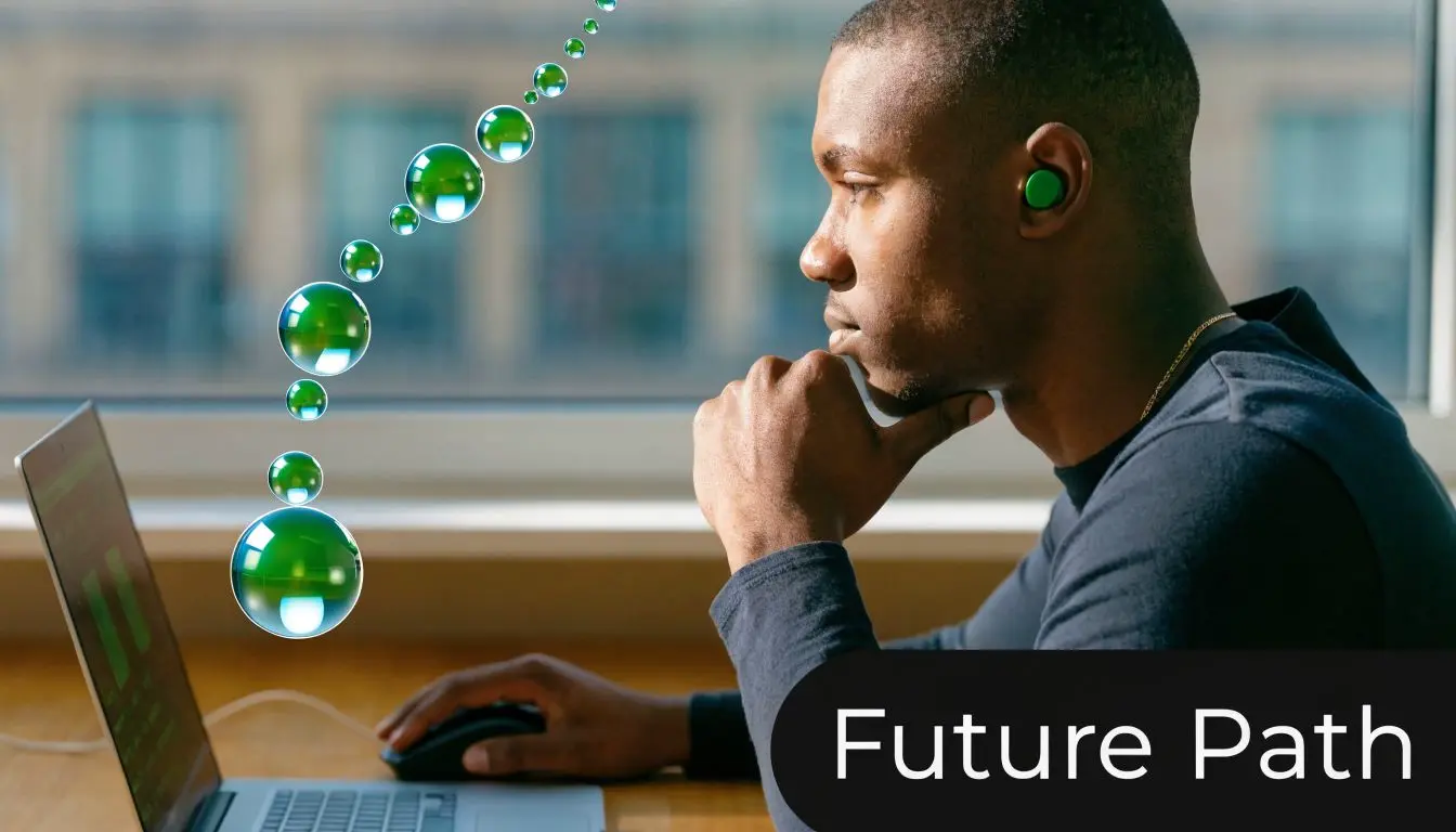 A young man sits at a desk focusing on a laptop with green bubble graphics floating above.
